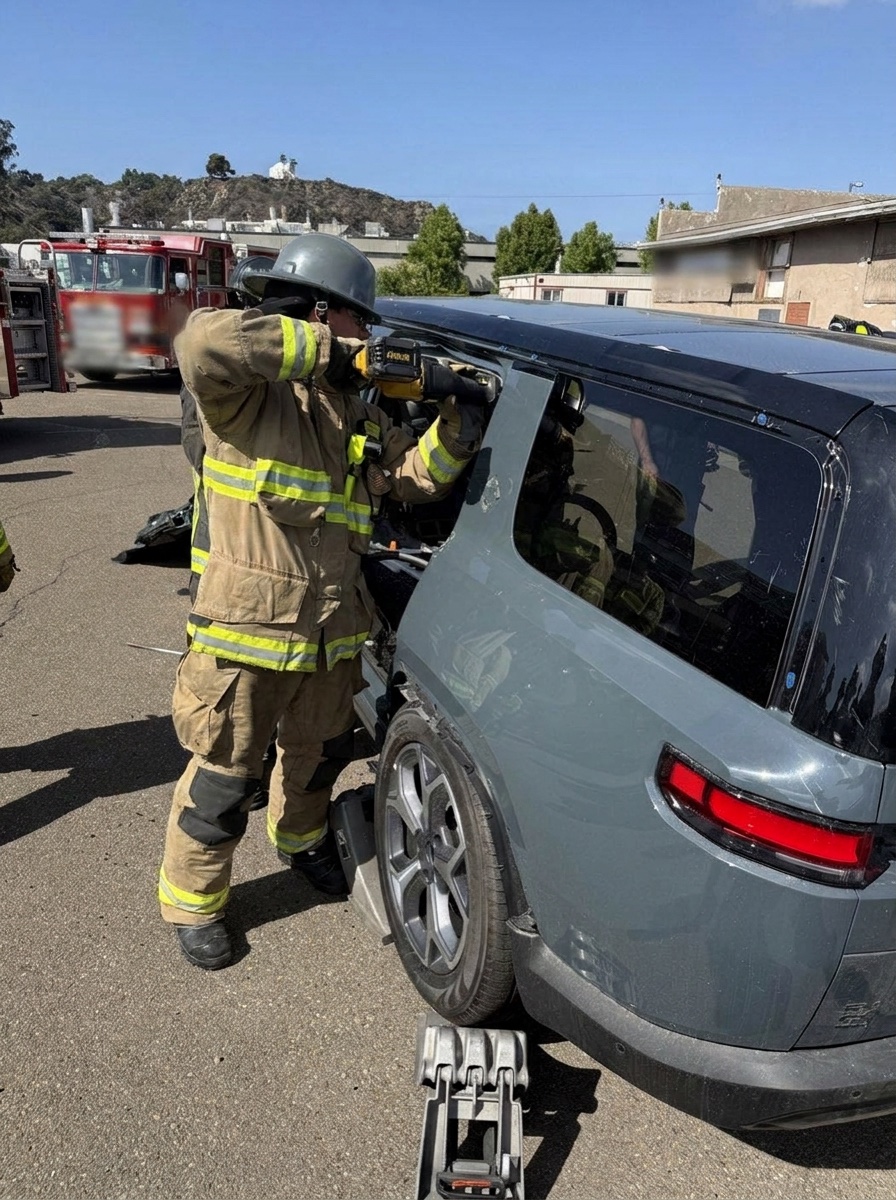 Firefighter cutting into an electric SUV